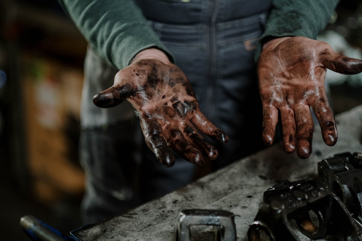 man with oil on his hands